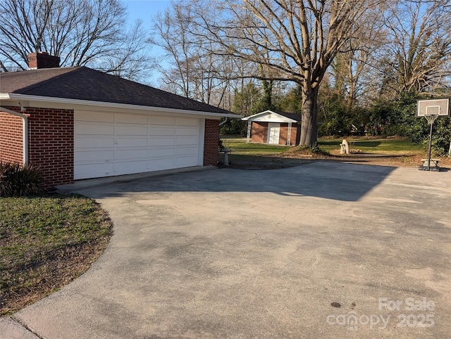 view of side of home featuring a shed and a garage