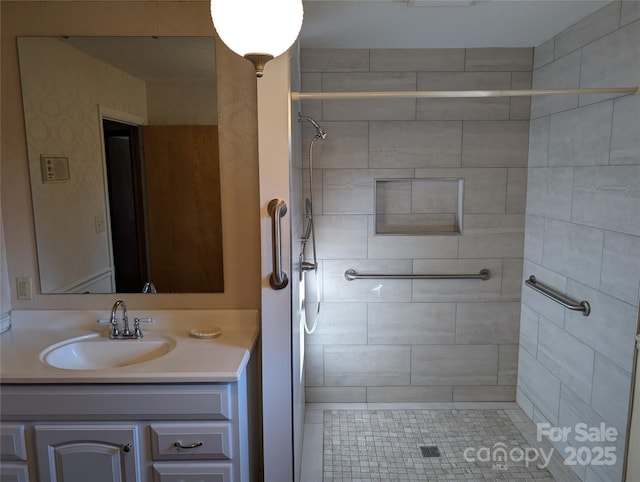 bathroom featuring vanity and a tile shower