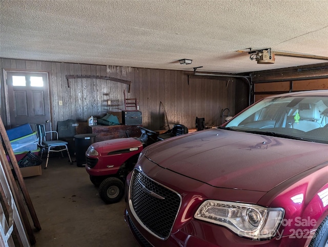 garage with a garage door opener and wooden walls