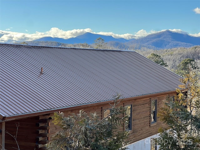 view of side of property with metal roof and a mountain view