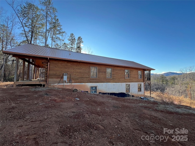 view of side of home with a mountain view