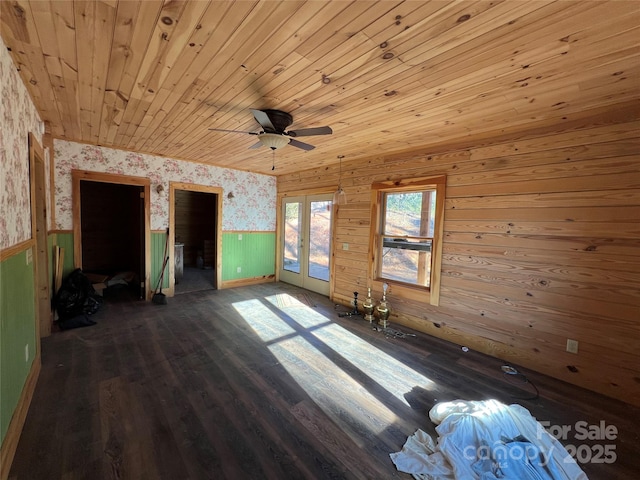 unfurnished bedroom featuring access to outside, ceiling fan, dark wood-type flooring, wooden ceiling, and french doors