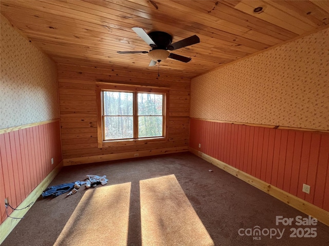 spare room featuring wood ceiling, carpet floors, and ceiling fan