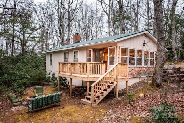 back of house featuring a wooden deck