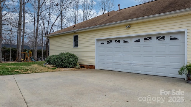 garage featuring concrete driveway