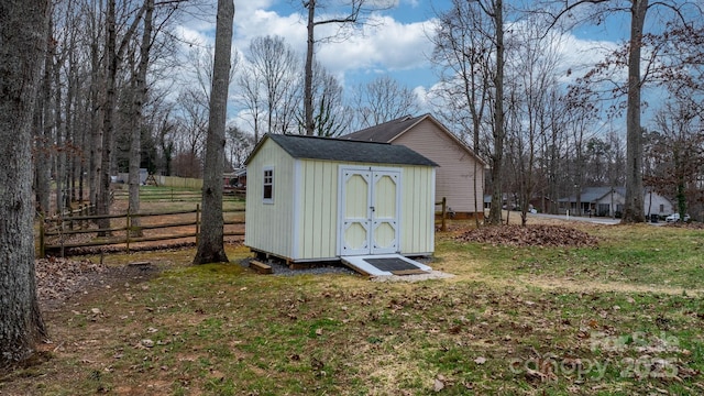 view of shed with fence