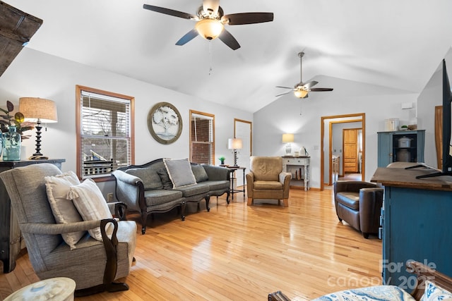 living area featuring vaulted ceiling, ceiling fan, and light wood-style flooring