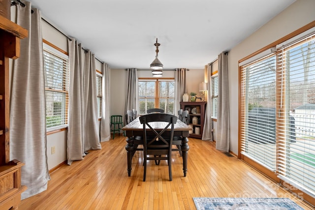 dining area featuring light wood-type flooring and baseboards