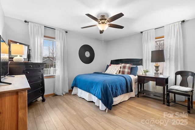 bedroom featuring baseboards, a ceiling fan, and light wood-style floors