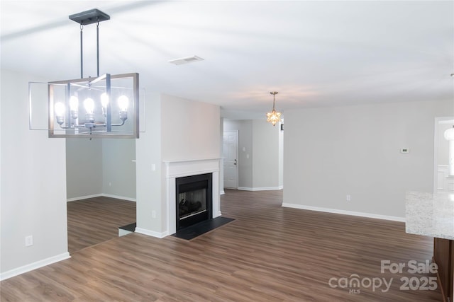 2043 Covered Bridge Ct, Rock Hill, SC 29732 - unfurnished living room with a chandelier, wood finished floors, baseboards, and a fireplace with flush hearth