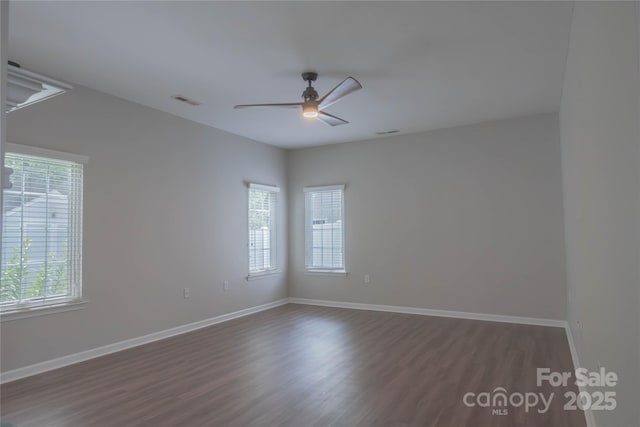 2043 Covered Bridge Ct, Rock Hill, SC 29732 - spare room featuring plenty of natural light, a ceiling fan, dark wood-style flooring, and baseboards