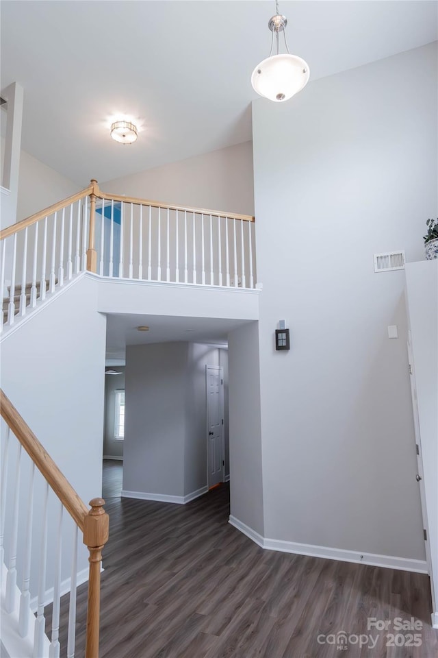 2043 Covered Bridge Ct, Rock Hill, SC 29732 - staircase featuring wood finished floors, a high ceiling, and baseboards