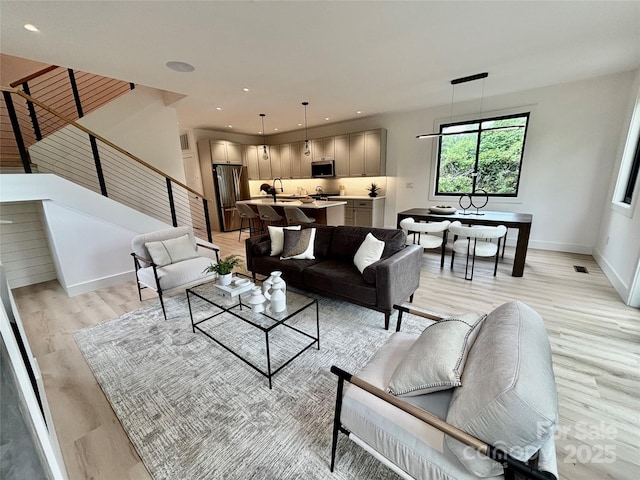 5 Dale St, Asheville, NC 28806 - living area with light wood-style flooring, stairway, and baseboards