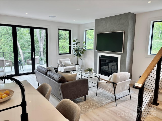 5 Dale St, Asheville, NC 28806 - living room with light wood-type flooring, a large fireplace, recessed lighting, and stairs