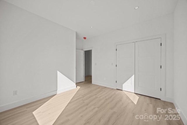 5 Dale St, Asheville, NC 28806 - unfurnished bedroom featuring light wood finished floors, baseboards, a closet, and recessed lighting