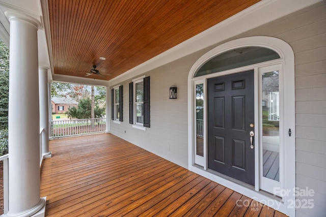 wooden terrace with a porch and a ceiling fan