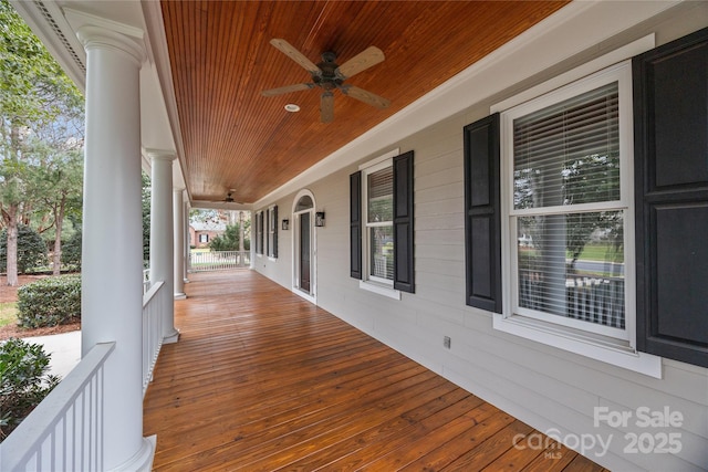 wooden terrace with a porch and ceiling fan