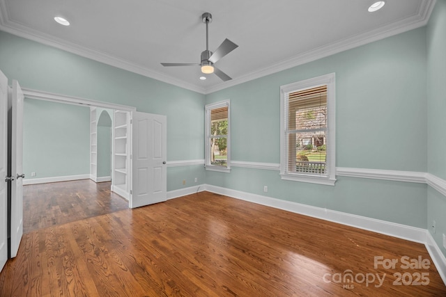 empty room with crown molding, recessed lighting, wood finished floors, and baseboards