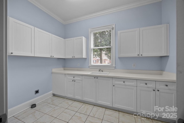 laundry room with crown molding, baseboards, laundry area, marble finish floor, and a sink