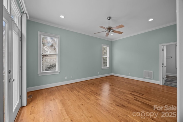 unfurnished bedroom with visible vents, multiple windows, and crown molding