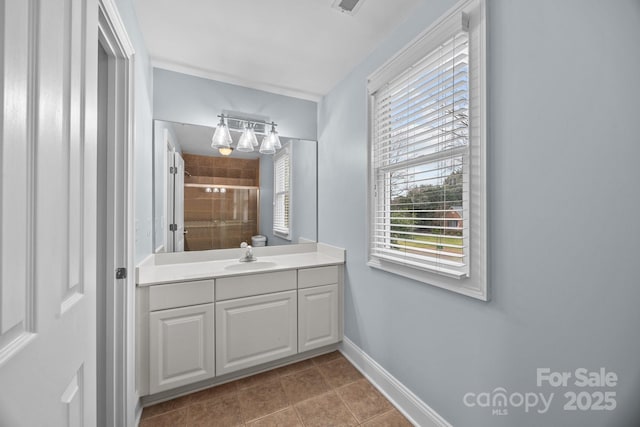 bathroom with tile patterned floors, baseboards, vanity, and a shower stall