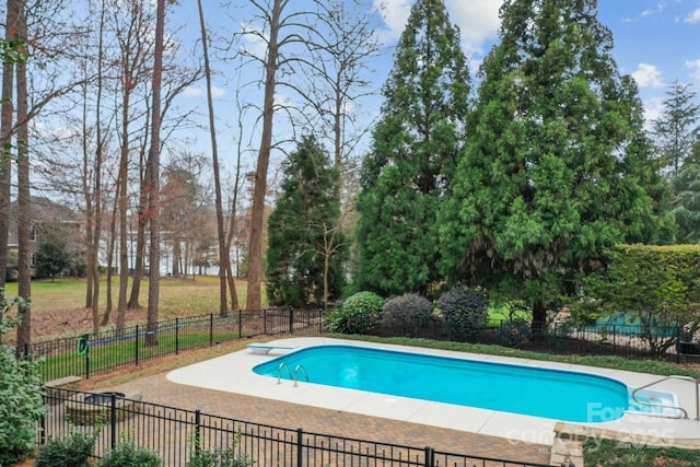 view of pool featuring a diving board, a fenced in pool, and fence