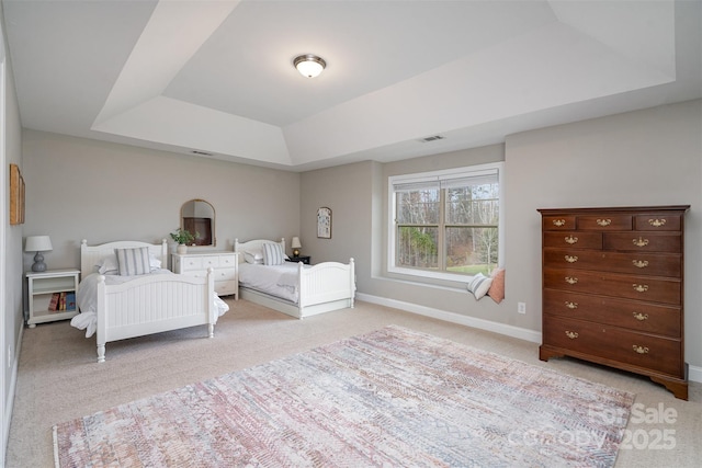 bedroom featuring baseboards, a raised ceiling, visible vents, and light colored carpet