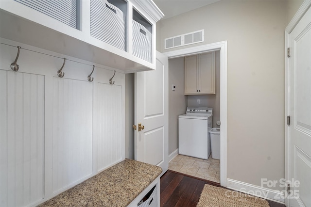 mudroom with visible vents, dark wood finished floors, washer / dryer, and baseboards