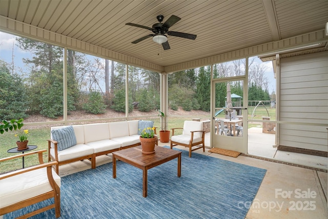 sunroom / solarium featuring ceiling fan