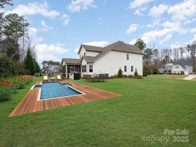 exterior space featuring a sunroom and a lawn