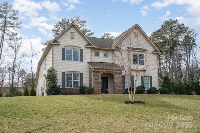 craftsman inspired home featuring metal roof, a front lawn, a standing seam roof, and stone siding