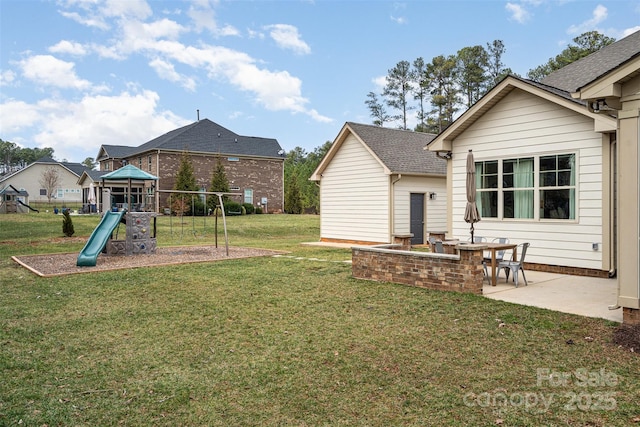 view of yard featuring a patio area and a playground