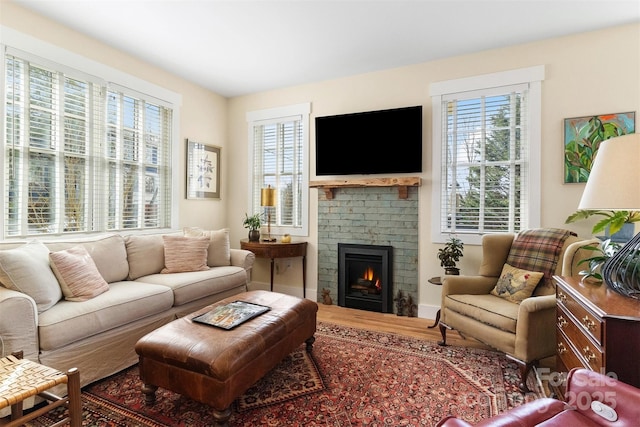 living room with a brick fireplace