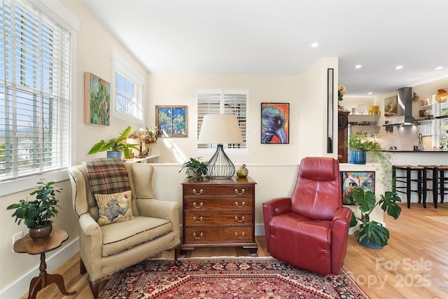 living area with hardwood / wood-style flooring