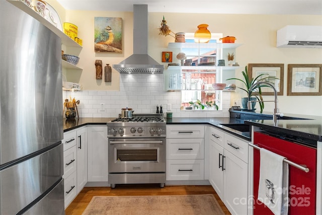 kitchen with white cabinetry, tasteful backsplash, a wall mounted air conditioner, island exhaust hood, and stainless steel appliances