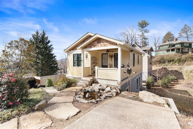 bungalow with a ceiling fan and fence