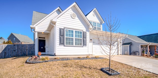 view of front of house featuring a garage and a front lawn