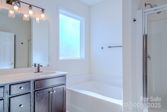 bathroom featuring vanity and independent shower and bath