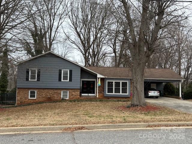 split level home with a carport and a front lawn