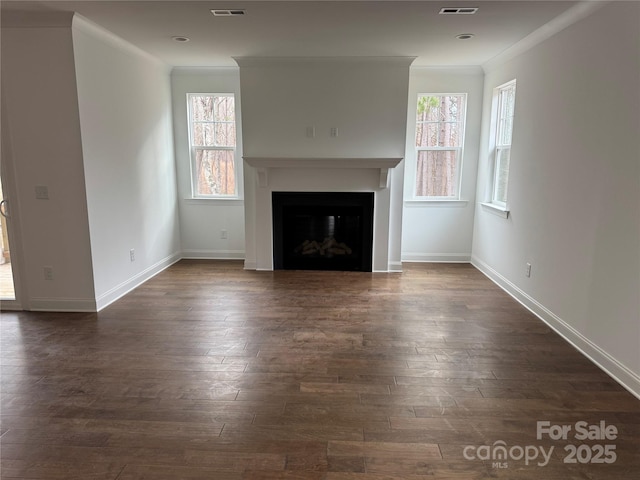 unfurnished living room with crown molding and dark hardwood / wood-style floors