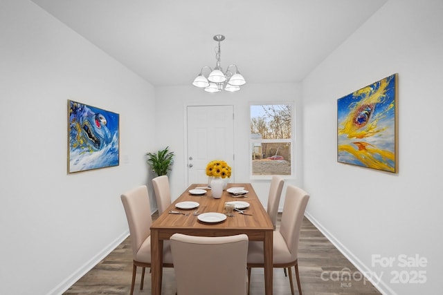 dining space with an inviting chandelier and dark wood-type flooring