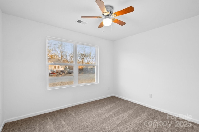 unfurnished room with ceiling fan and carpet