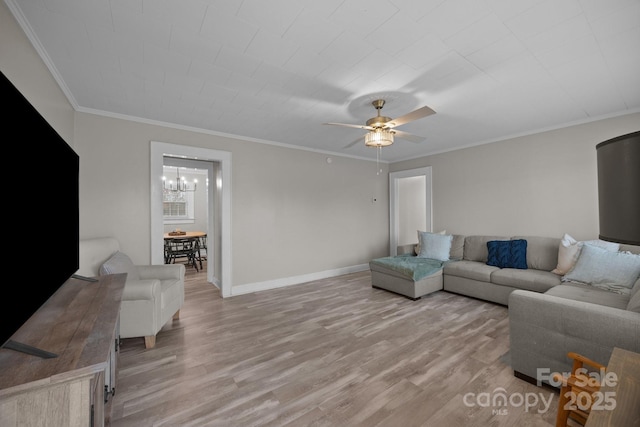 living room featuring ceiling fan with notable chandelier, light hardwood / wood-style flooring, and ornamental molding