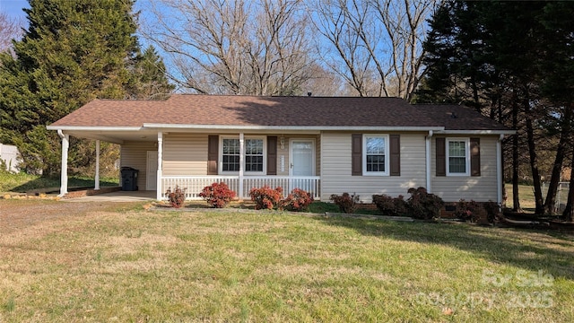 ranch-style home featuring a carport, a porch, and a front yard