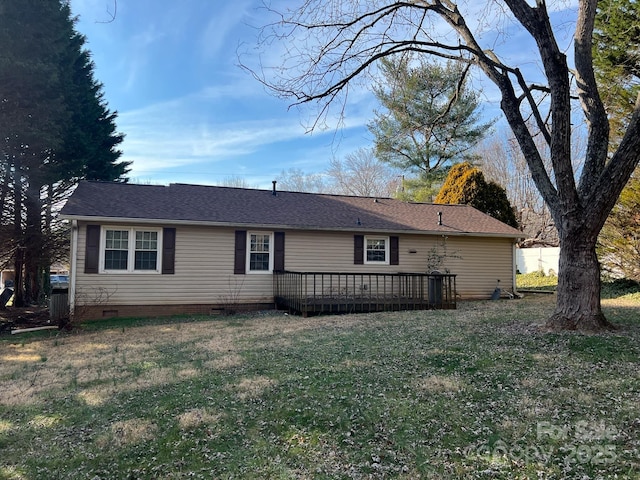 rear view of property featuring a yard and a deck