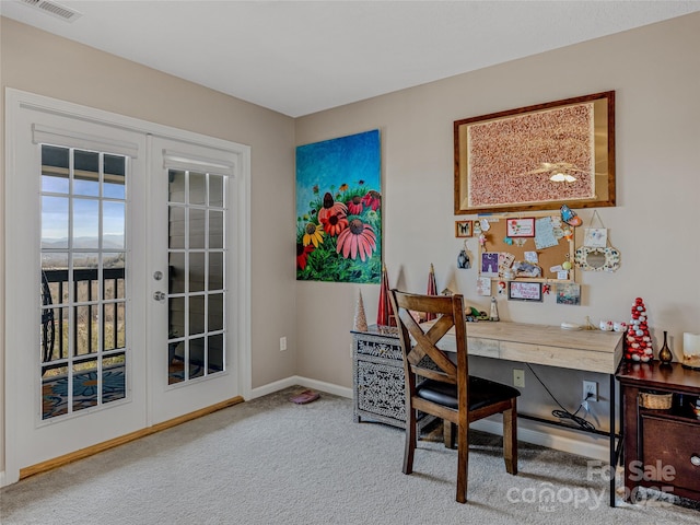 carpeted office with french doors