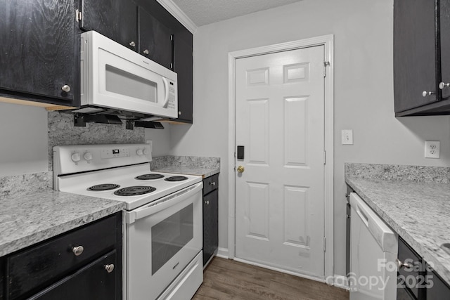 kitchen featuring white appliances, dark hardwood / wood-style flooring, and a textured ceiling