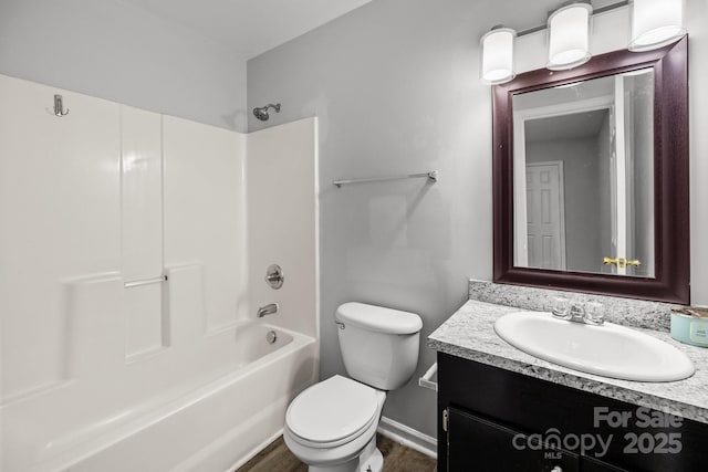 full bathroom featuring bathtub / shower combination, vanity, and toilet