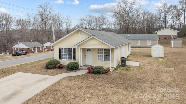 single story home featuring a storage unit and a front yard