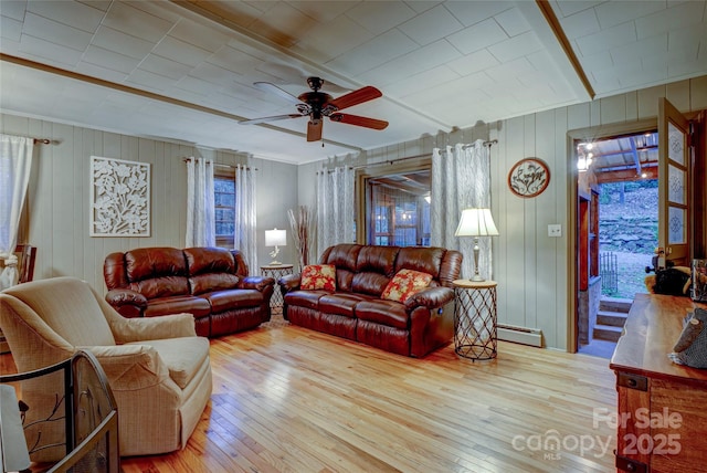 living room with a baseboard radiator, ceiling fan, and light hardwood / wood-style flooring